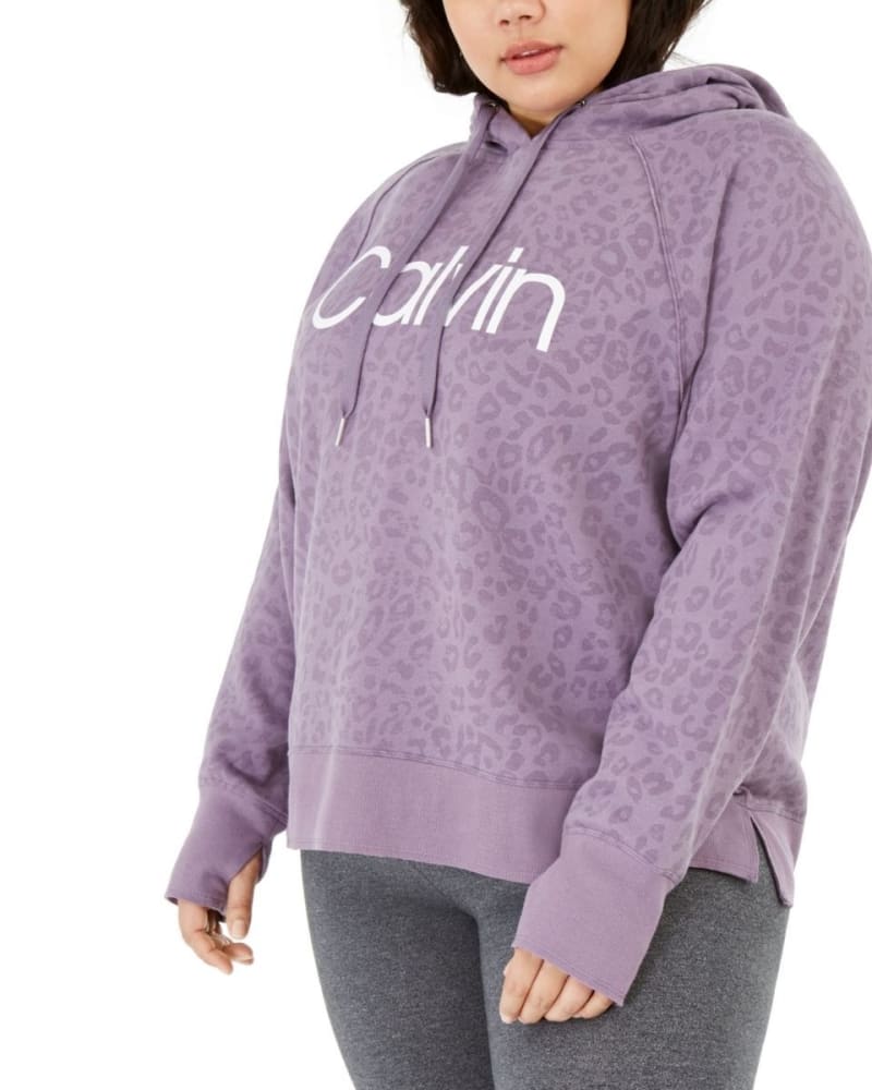 Front of a model wearing a size 1X Calvin Klein Women's Performance Plus Size Animal-Print Hooded Sweatshirt Purple Size 1X in Purple by Calvin Klein. | dia_product_style_image_id:313668